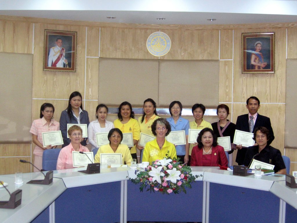 Thai teachers at Burapha University receive an award for completion of a three-month program in faculty development from Dr. Rana Pongreungphant, Vice President, presiding with Fulbright Scholar Celeste Brody.