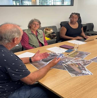 Lekelia Jenkins with Fulbright host, Claudia Baldwin, and a Queensland commercial fisher discussing photos the fisher took as part of the photovoice process